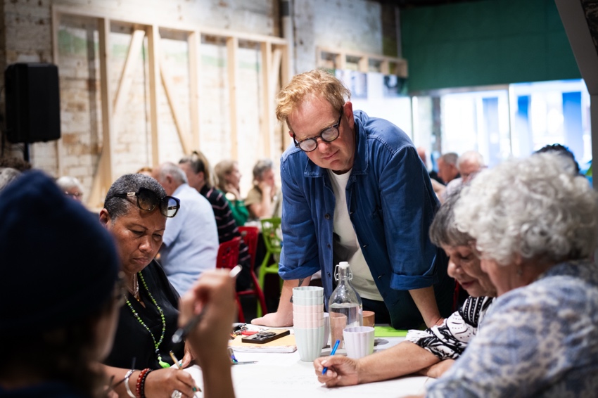 A group of people sitting around a table

AI-generated content may be incorrect.