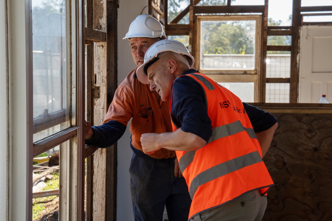 A group of men in hardhats looking at a window

AI-generated content may be incorrect.