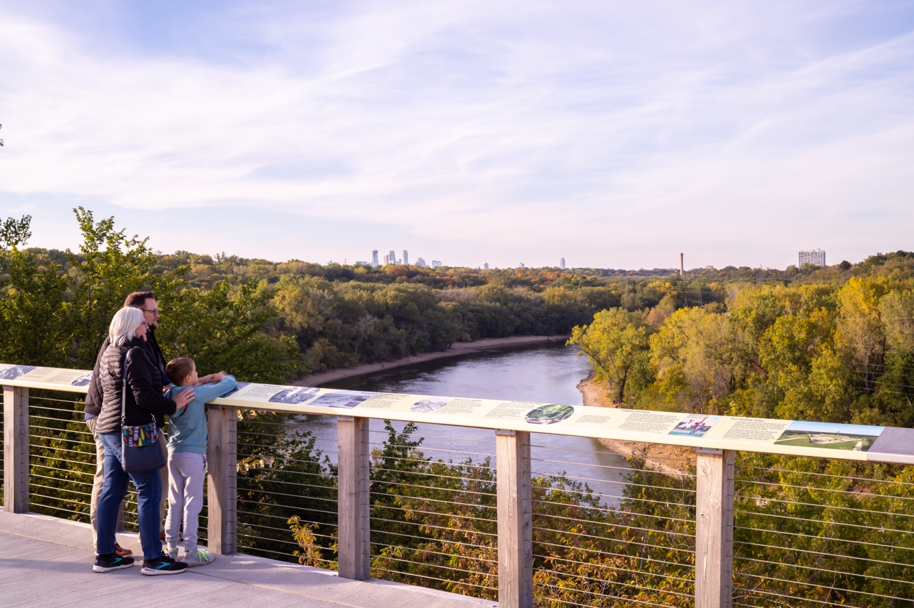 A person and person standing on a bridge overlooking a river

AI-generated content may be incorrect.
